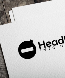 headlong-into-harm-logo-on-paper-on-wood-desk